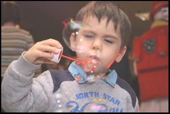 FH young boy blowing bubbles